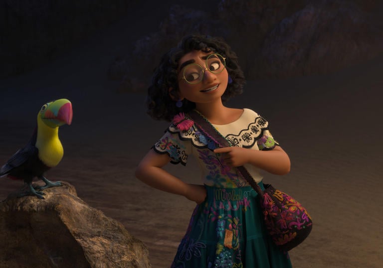 Animated still from Encanto of a tropical bird on a rock and lead character