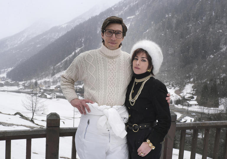 Adam Driver and Lady Gaga posing in character in front of a mountain snow scene