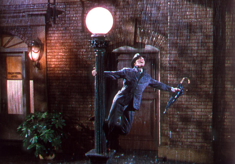 Gene Kelly standing on a lamppost in Singin' in the Rain