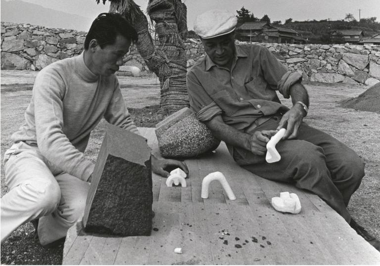 Isamu Noguchi studying models with Masatoshi Izumi in Mure, Japan, c.1970s