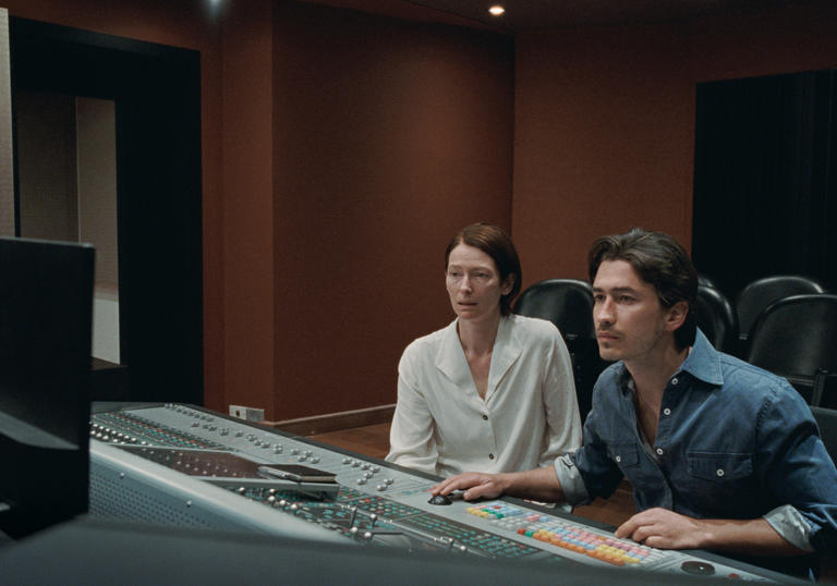 Tilda Swinton and Juan Pablo Urrega sit at a mixing desk in Memoria