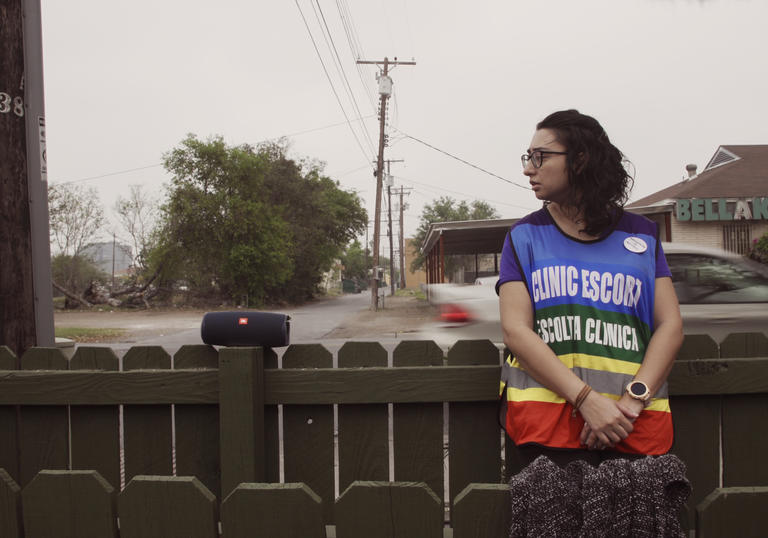 A young woman in a still from On the Divide