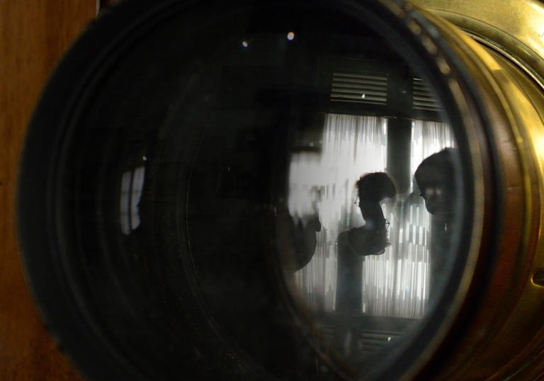 camera lens with person in reflection