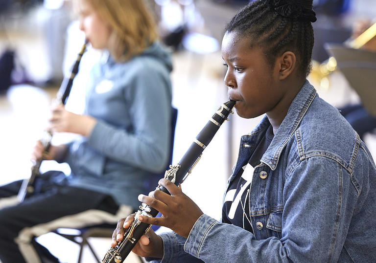 Young black female playing clarinet
