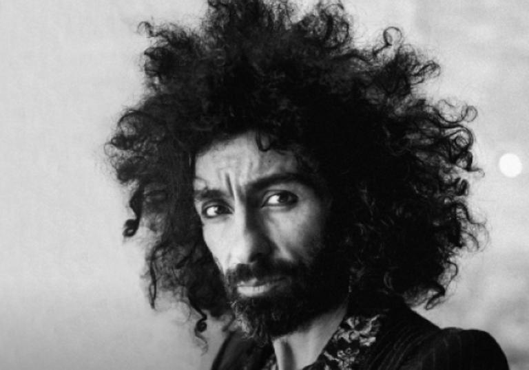 Ara Malikian looking into the camera. He has dark curly hair and facial hair.