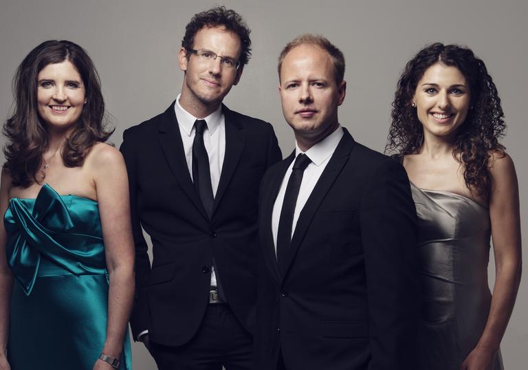 Photo of Carducci Quartet in formal dress smiling at the camera