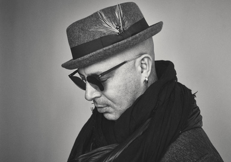 a black and white side profile photo of Dhafer Youssef