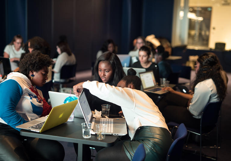 Group of young people at a table participating in a workshop