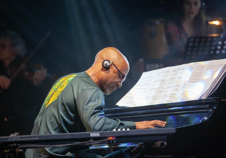 a live performance photo of Frederic Gassita playing piano