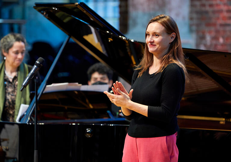 Presenter Rachel Leach clapping.