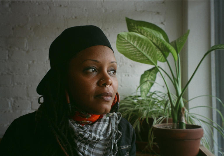 photo of Matana Roberts next to a plant