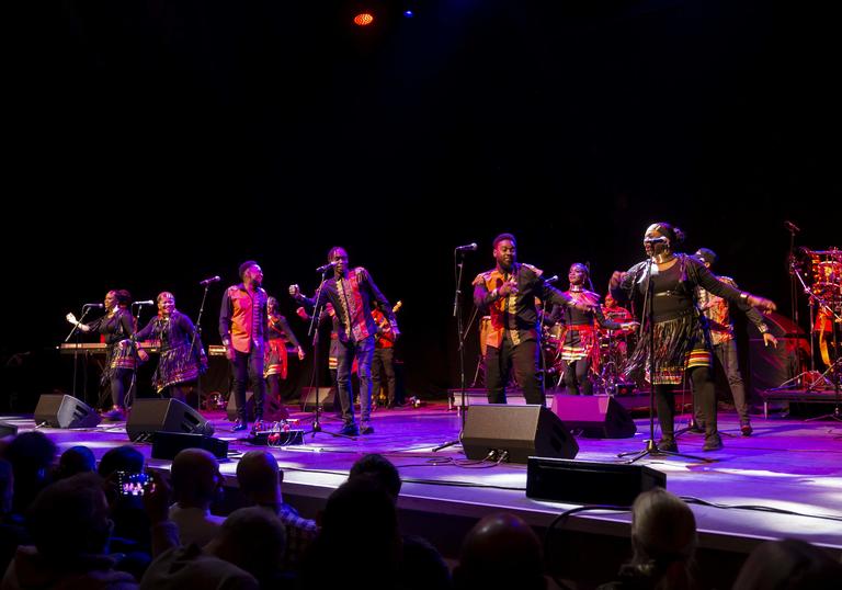 Colour photo of the gospel choir singing and dancing on stage