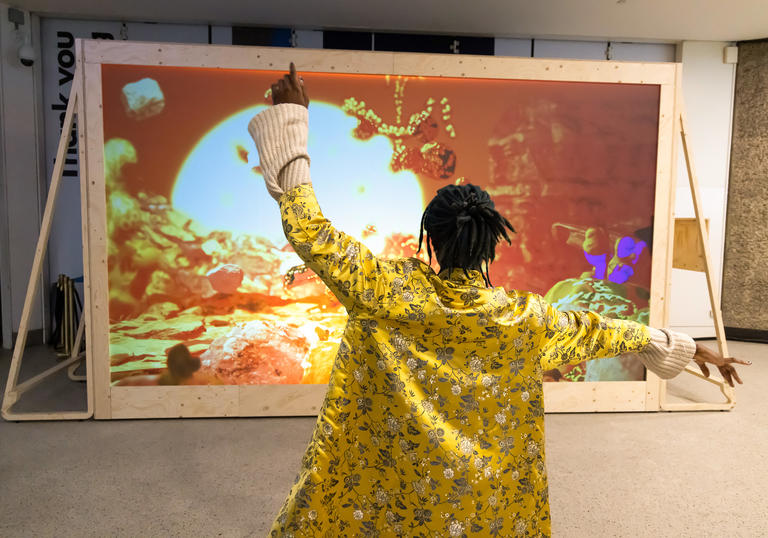 Person dancing in front of installation