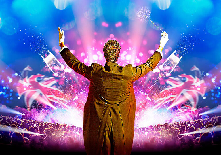 Image of a conductor from behind, in front of a crowd and Union Jack flags