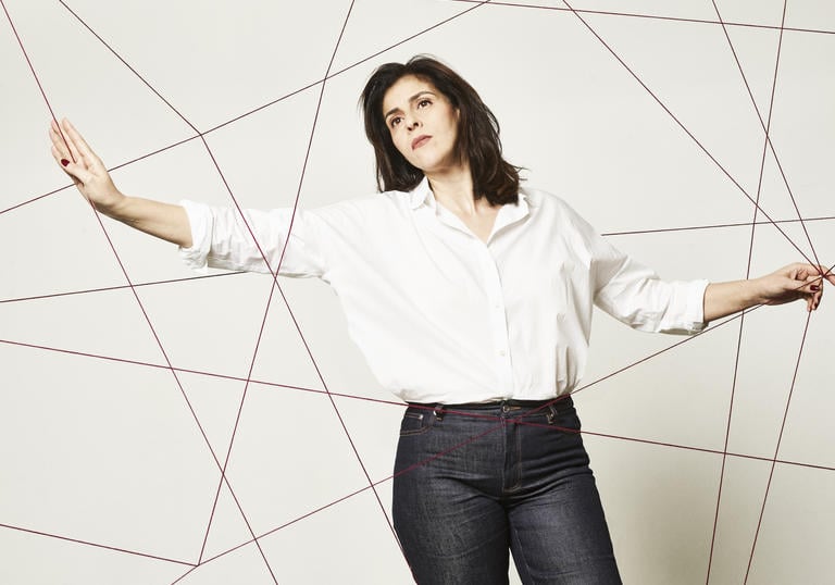 Picture of Souad Massi in front of artistic string background