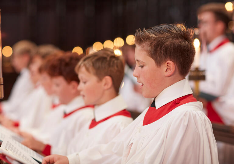 Members of the King's College Choir, Cambridge, sing in their cassocks