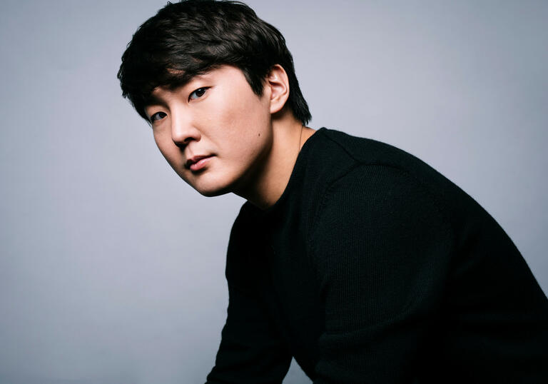 Seong-Jin Cho looking at the camera against a white background