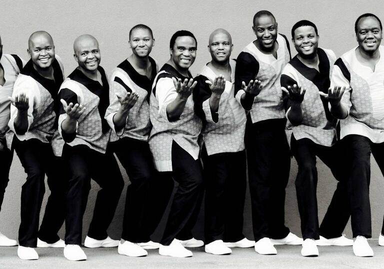 Shot of Ladysmith Black Mambazo in a line posing and smiling