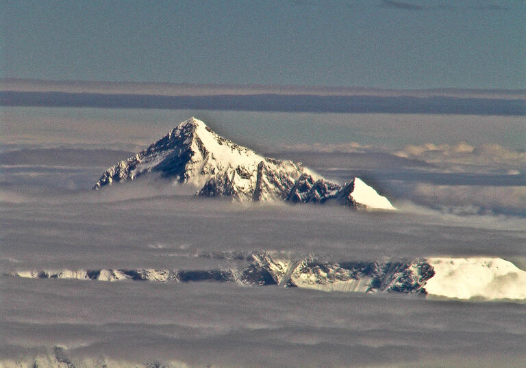 The peak of Mount Everest above the clouds