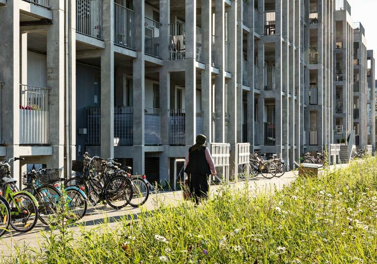 a photo of a person walking in front of a building