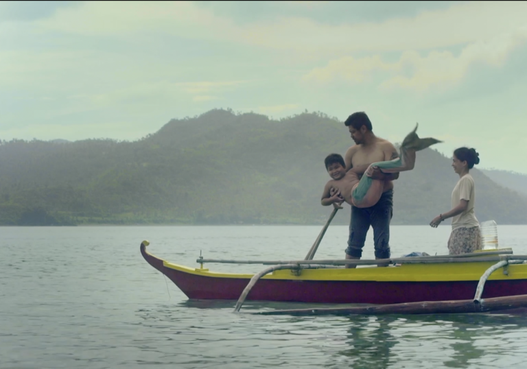 A man stands with his mermaid  