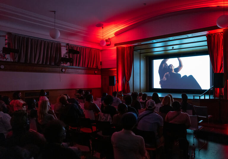 Audience watching a film on an elevated screen