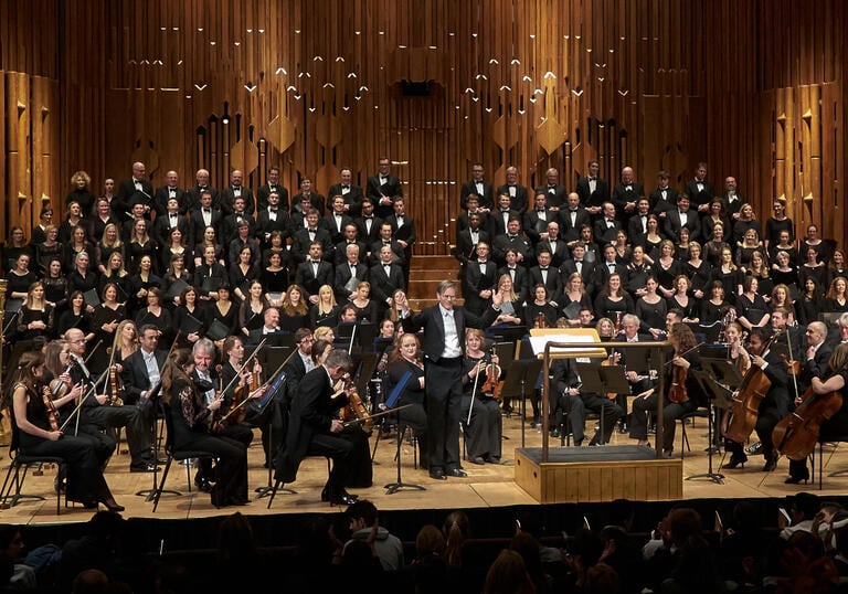 Photo of choir on stage in the Barbican Hall
