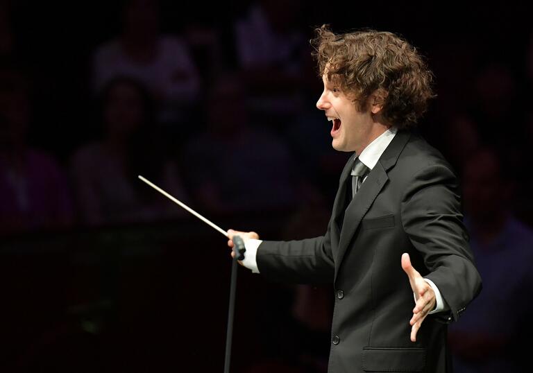 Action shot of conductor Nicholas Collon