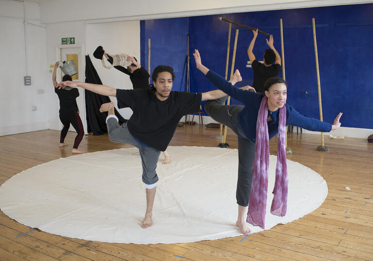 5 people engaging in contemporary dance with circle mat on the ground, 2 people at the front, 3 at the back