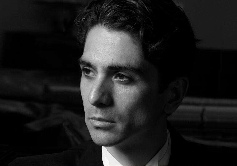 Close up black and white photo of Alexandros Kapelis 