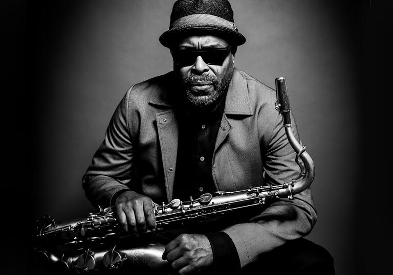 Black and white image of Jean Toussaint holding saxophone