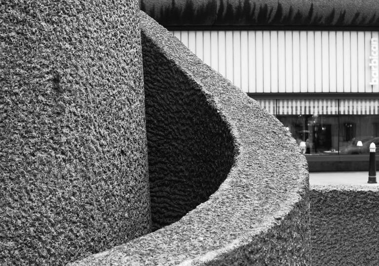 A black and white close-up photo of a concrete spiral structure.