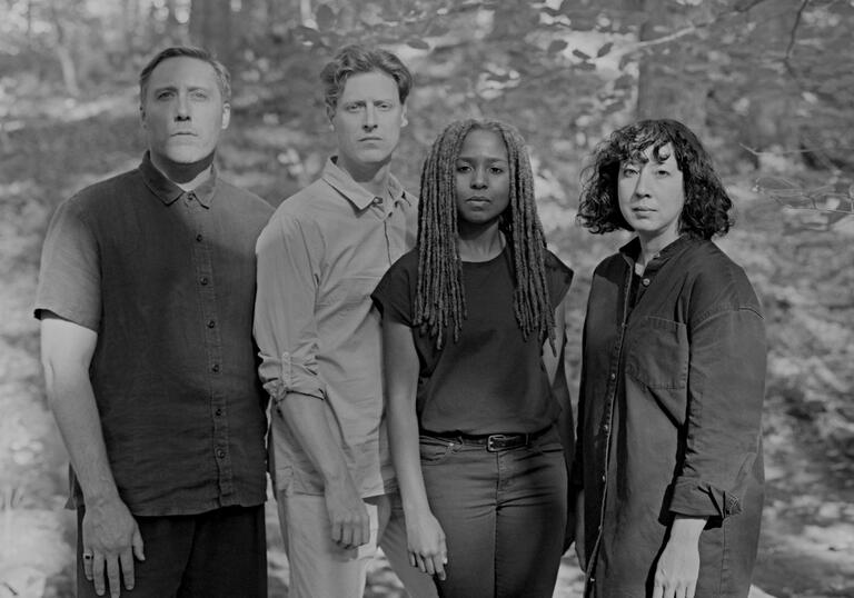 Group shot of Balmorhea Group in a forest