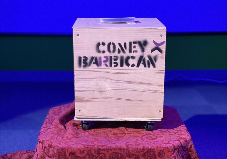 Box on table against blue backdrop
