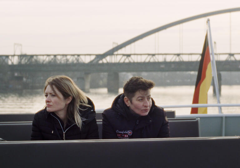 Two women sit on a boat