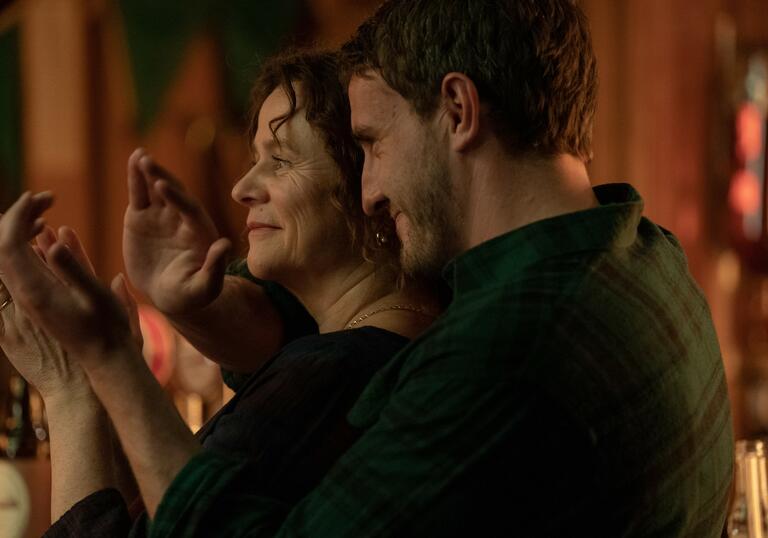 A mother and her grown up son dance happily together in a still from God's Creatures