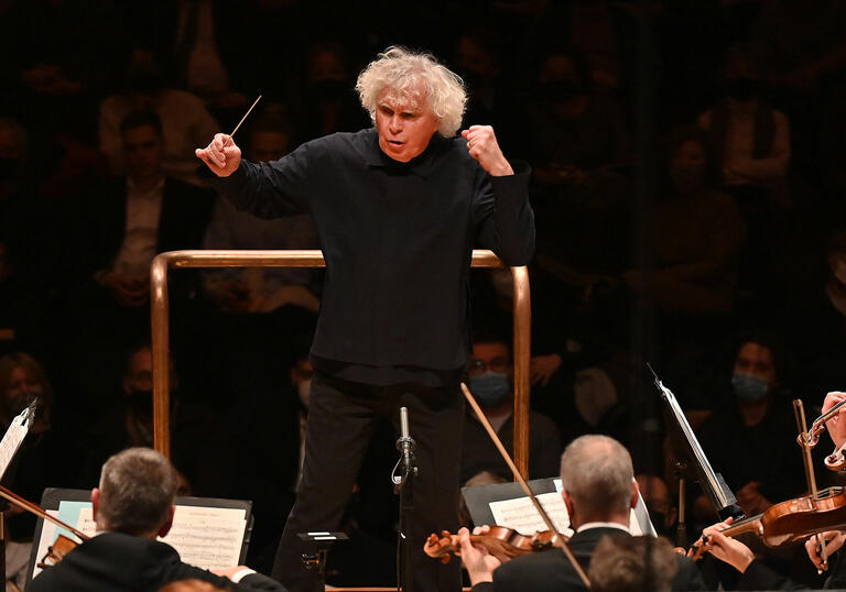 Sir Simon Rattle conducting