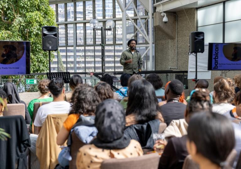 Man standing on stage in front of audience