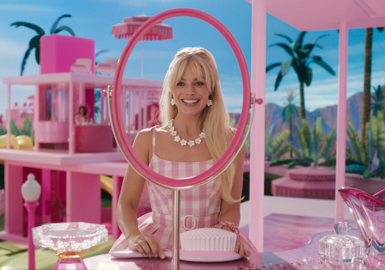 Barbie gets ready at her dresser in Barbieland