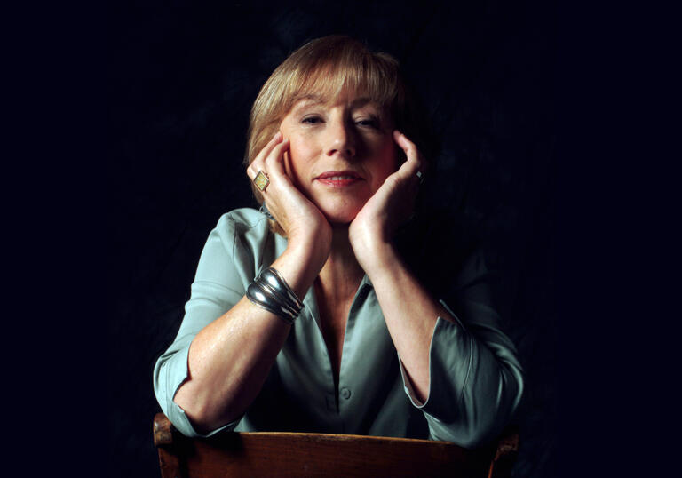 Norma Winstone sitting on chair with hands close to face