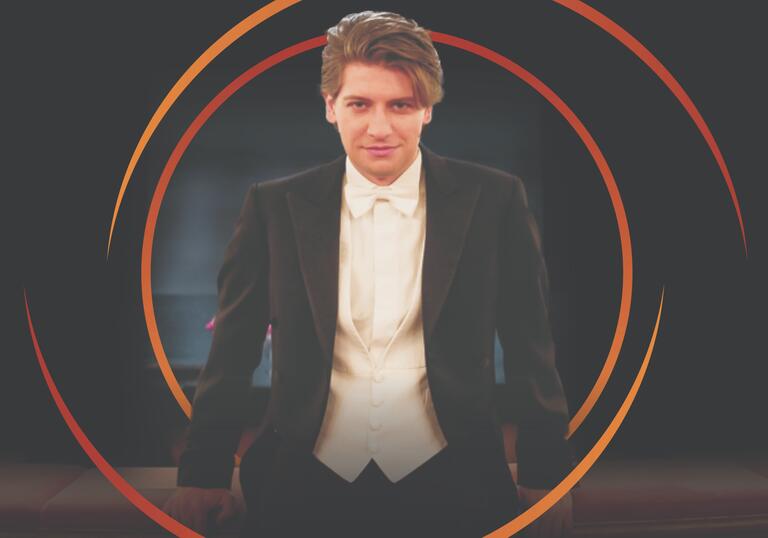 Daniele Rustioni looking at the camera, with circular orange swirls around him