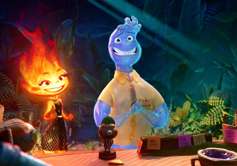 A fire person and a water person look at each other at a table.