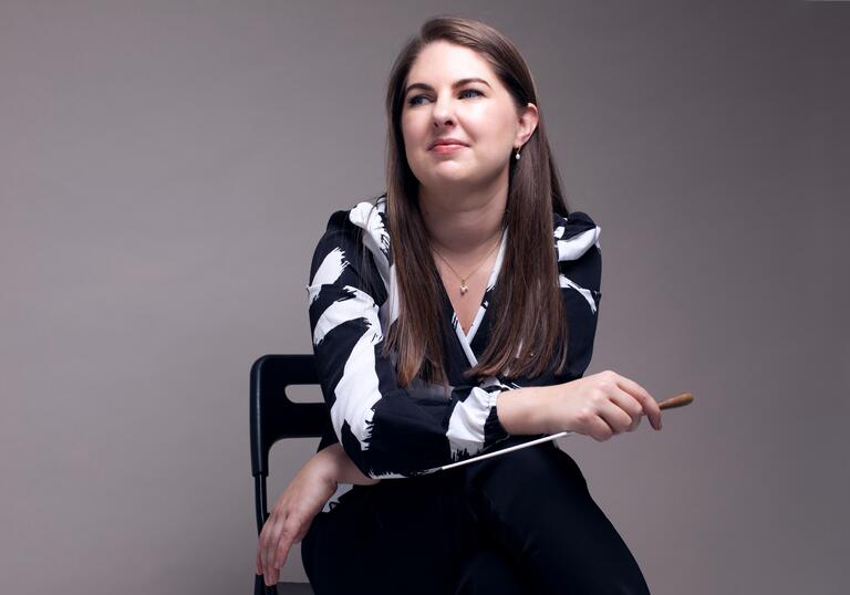 Karen Ni Bhroin sitting down holding her baton