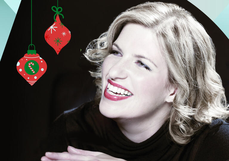 Clare Teal smiling, with turquoise and orange shapes bordering the image and two Christmas baubles hanging from the top of the image