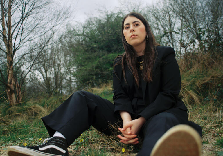 Sorcha Richardson sits in the middle of a woodland clearing