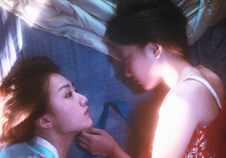 Two women stare into each others eyes