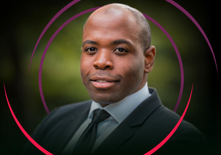 Tenor Joshua Stewart smiling at the camera, with red and purple circular swirls around him