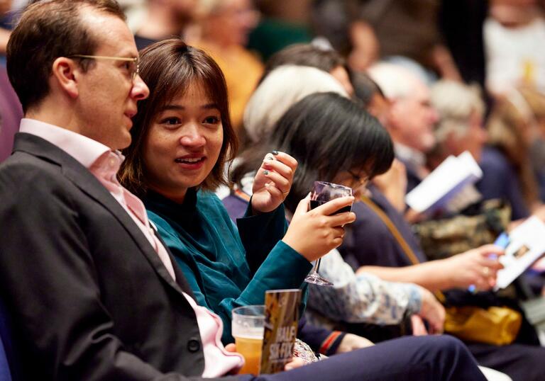 Audience members talking to each other at a Half Six Fix concert.