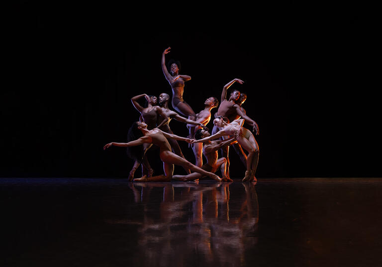 Members of the Ballet Black ensemble pose together, they move fluidly between and around one another.