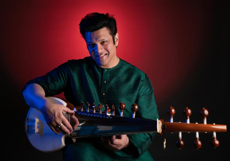 Amaan Ali Bangash holding a sarod